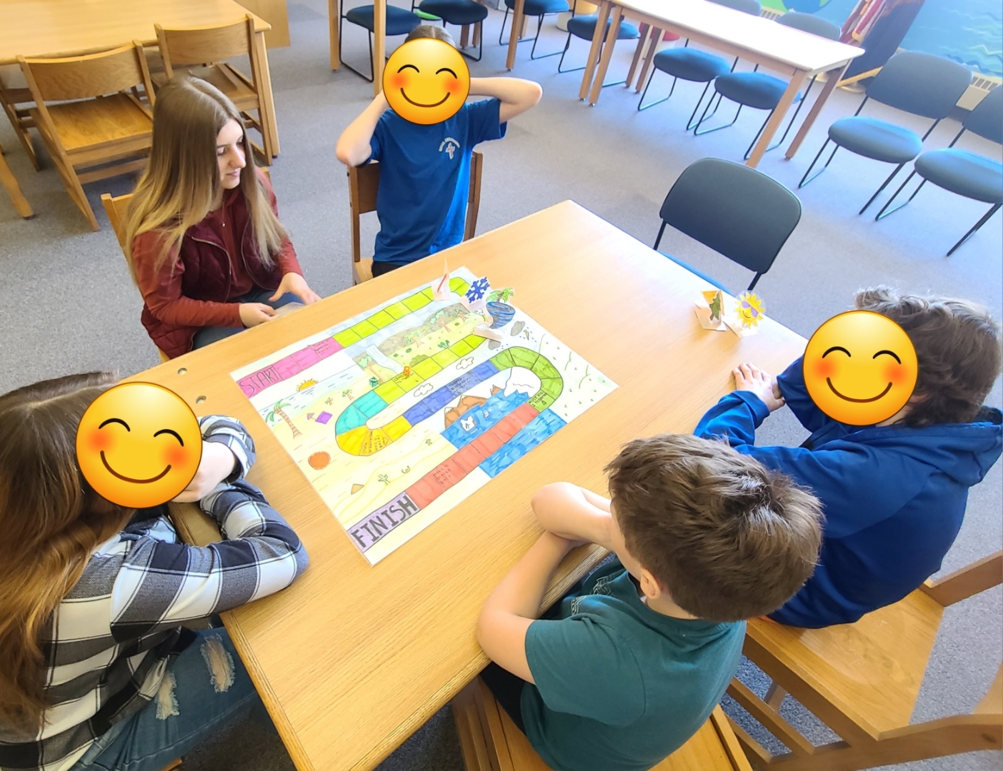 HS student teaching a game to younger students