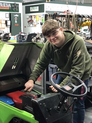 Student working on a lawnmower.