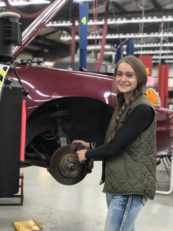 Student of the Month, Bethany Sides, is pictured working on an automobile.