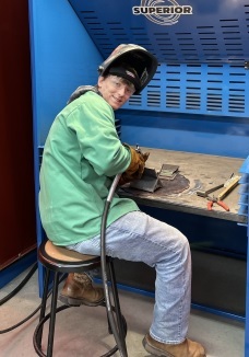 Photo of student in his welding booth.